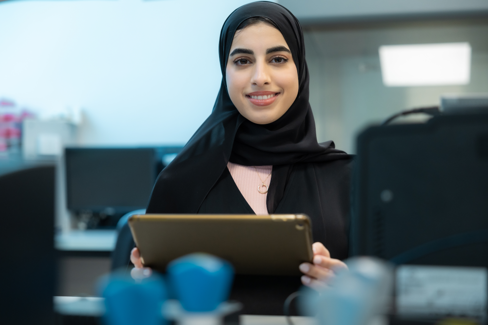 A female student holding a tablet computer.