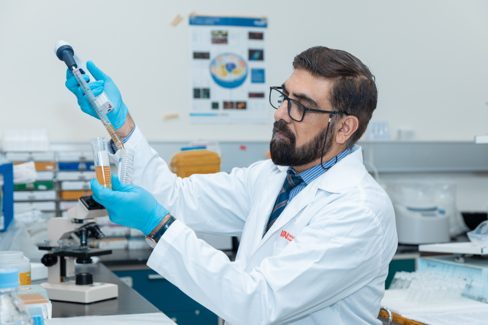 Scientist analyzing liquid samples in a laboratory.